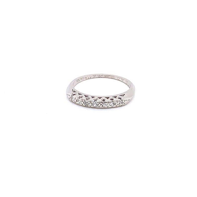 May include: A silver band with a row of small diamonds set in a half-round design.