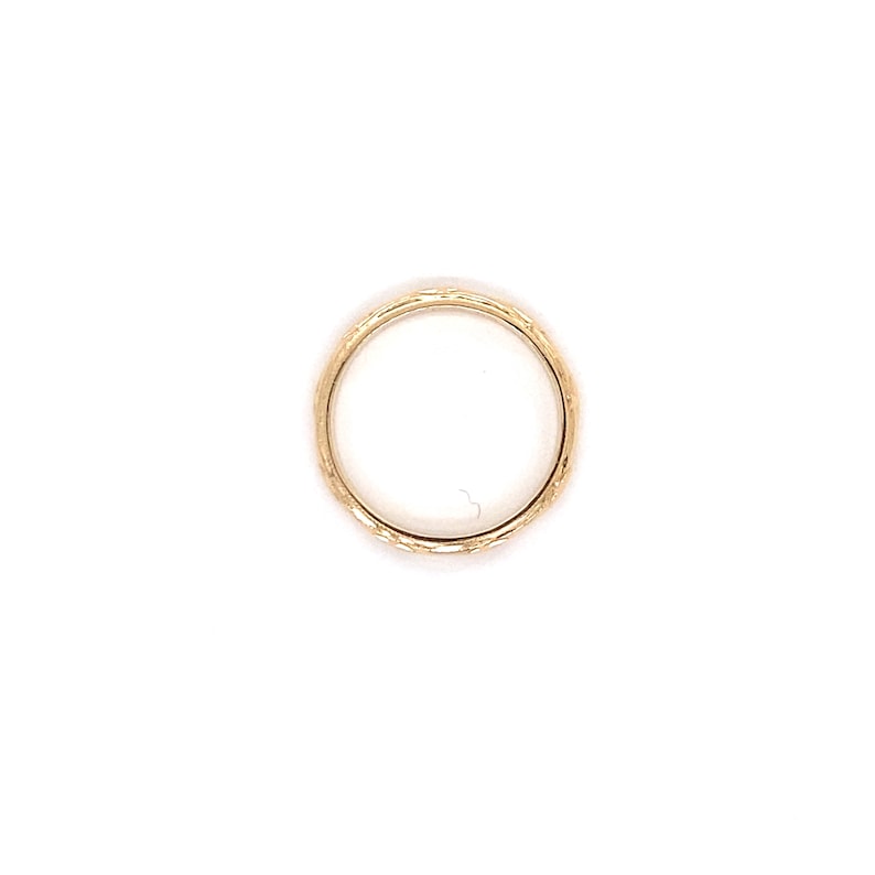 May include: A gold band ring with a textured surface.