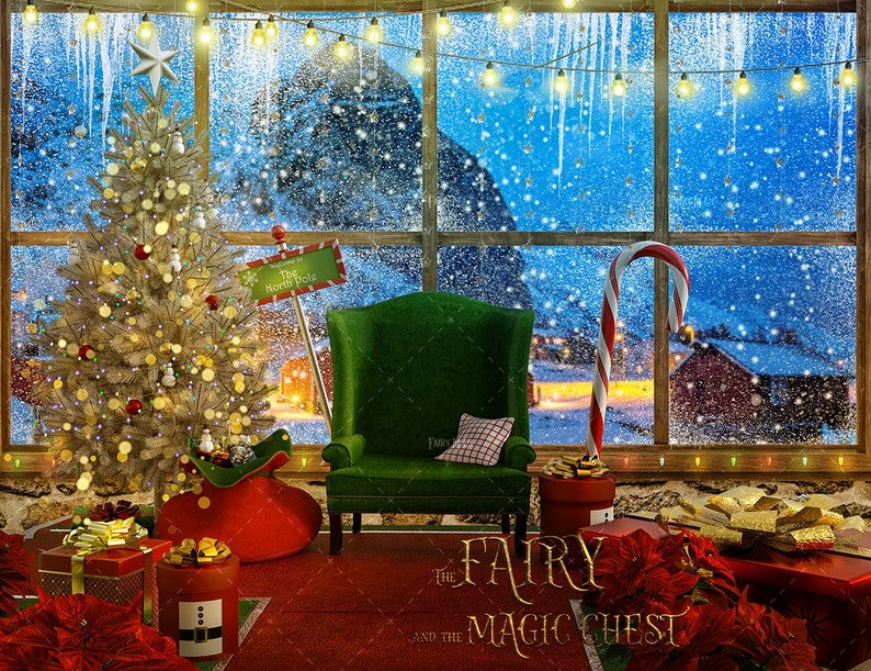 May include: A Christmas scene with a decorated tree, a green armchair, and a candy cane. The window behind the scene shows a snowy landscape with a sign that reads "The North Pole". The text "The Fairy and the Magic Chest" is written on the floor in front of the armchair.