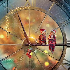 May include: Two children wearing Santa hats are sitting on a clock face with a blurred background of Christmas lights. The clock face is made of metal and has a gold finish. The children are holding small gifts and smiling.