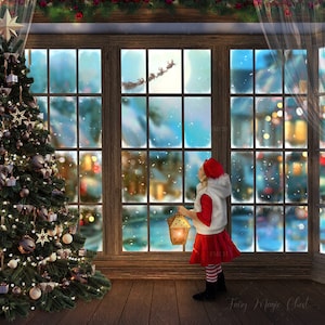 May include: A girl in a red and white Santa suit stands in front of a large window with a Christmas tree to the left. The window is decorated with a snowy scene and a flying Santa Claus. The girl is holding a lantern.