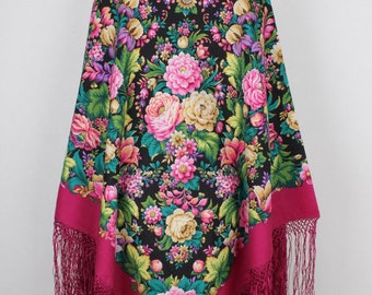 May include: A traditional Russian shawl with a black background and a floral pattern in shades of pink, yellow, green, and purple. The shawl has a crimson border and fringe.