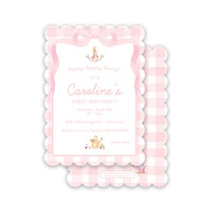 May include: Pink and white gingham patterned invitation with a scalloped edge. The invitation is for Caroline's first birthday party. It includes the date, time, and location of the party. The invitation also includes a small illustration of a rabbit holding a watering can.