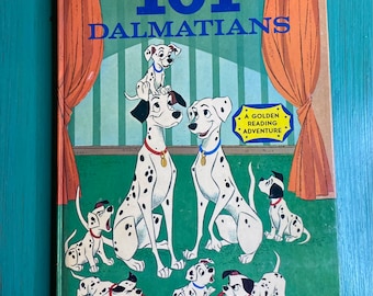Pode incluir: Uma capa de livro infantil vintage com os 101 dálmatas da Walt Disney. A capa mostra uma família de cães dálmatas com manchas pretas sobre um fundo verde. O título "Walt Disney 101 Dálmatas" está em letras azuis e brancas. O livro faz parte de uma série "Golden Reading Adventure".