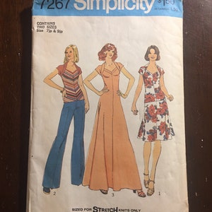 May include: Simplicity sewing pattern number 7267 for stretch knits. The pattern includes instructions for three garments: a long dress, a shorter dress, and a top with pants. The pattern is sized for 7jp and 9jp.