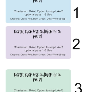 May include: Three light blue, purple, and green cards with the text "Never, ever use a joker in a pair!"  Charleston: R-A-L Option to stop L-A-R optional pass 1-3 tiles Dragons: Crack-Red, Bam-Green, Dots-White (Soap). The cards are numbered 1, 2, and 3.