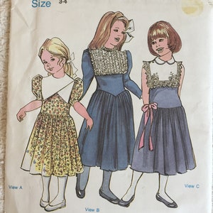 May include: A set of three ceramic mugs with a speckled, matte finish. The mugs are in shades of cream, light gray, and dark gray. Each mug has a simple, minimalist design and a rounded handle.