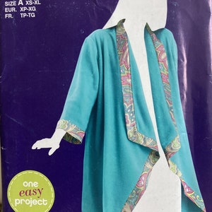 May include: A Simplicity SewSimple sewing pattern envelope E2002 for a teal jacket with a paisley trim. The pattern is labeled as one easy project and includes sizes XS-XL. The envelope features a purple background with white text and a barcode.