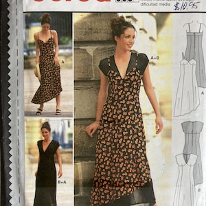 May include: A Burda dressmaking pattern featuring three dress designs. The dresses are shown in black fabric with orange floral patterns. The pattern includes sizes 8-18 and the text "THE NEW burda".