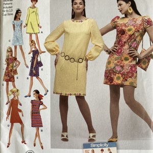 May include: Simplicity sewing pattern 2967 for dresses in sizes H5 6, 8, 10, 12, 14. The envelope features illustrations of various dress styles, including a yellow long-sleeved dress with floral trim and a multi-colored floral print short-sleeved dress.