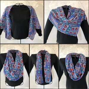 May include: A blue and orange patterned infinity scarf can be worn in multiple ways, including as a neck scarf, a shawl, or a headband.