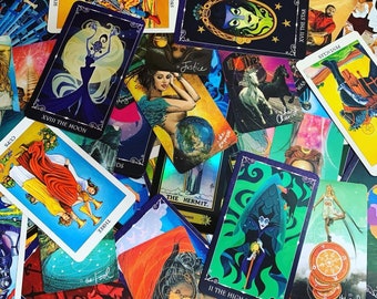 May include: A collection of tarot cards with colorful illustrations and text. The cards are spread out on a surface, showing a variety of suits and themes. The cards include the "The Hermit", "The High Priestess", "The Star", "The Moon", "The Chariot", "The Fool", "Justice", "Three of Cups", "Seven of Swords", "XVIII", and "DS".