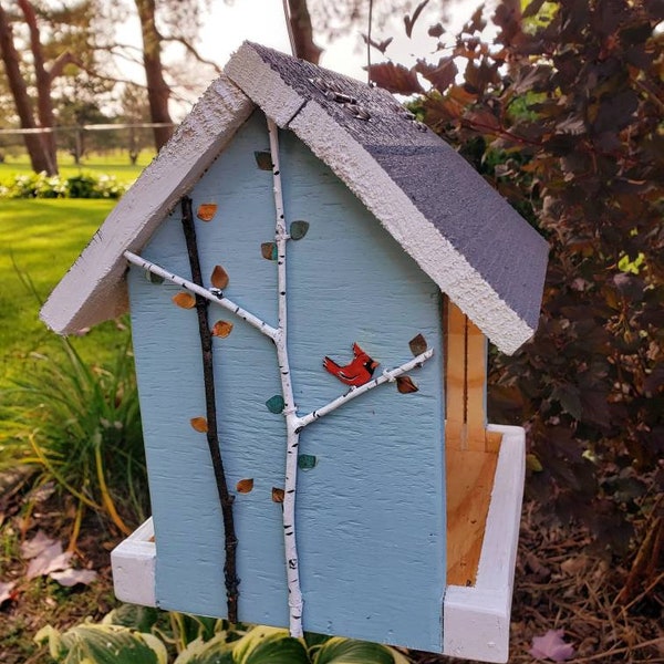 Colorful handmade wood bird feeder, hand painted birds and tree branches.