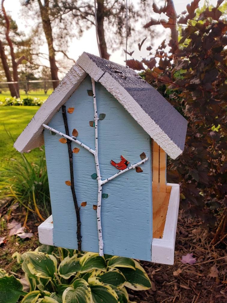 Colorful handmade wood bird feeder, hand painted birds and tree branches.