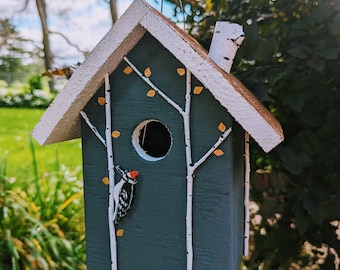 Handmade wood birdhouse with handcut and painted woodpecker. Hand painted tree branches and copper leaves.