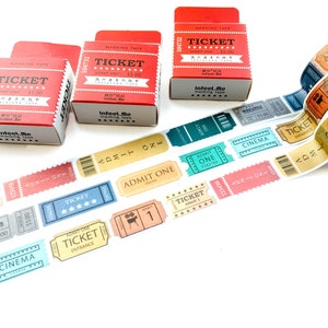 May include: Assortment of colourful washi tape rolls with a ticket theme. The tape features designs like "Admit One", "Cinema", and "Ticket" in various fonts and colours. The tape is packaged in red and white boxes with the text "Infeel.me Masking Tape" printed on them.