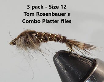May include: A close-up of a fishing fly with a brown body, gold wire wrapping, and a small hook. The fly is labeled "Tom Rosenbauer's Combo Platter flies" and is size 12.