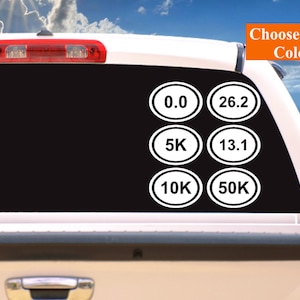 May include: White oval stickers with running distances printed in black on a black background. The stickers include 0.0, 5K, 10K, 13.1, 26.2, and 50K.