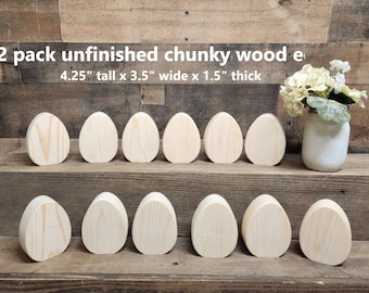 May include: Twelve unfinished wooden eggs, each measuring 4.25 inches tall, 3.5 inches wide, and 1.5 inches thick. The eggs are arranged in two rows on a wooden surface.