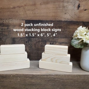 May include: Two sets of unfinished wooden stacking blocks. Each set includes three blocks, measuring 1.5 inches by 1.5 inches by 6 inches, 5 inches, and 4 inches. The blocks are arranged in a pyramid shape.