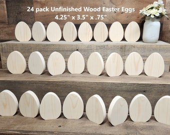 May include: 24 pack of unfinished wooden Easter eggs, 4.25 inches by 3.5 inches by 0.75 inches. The eggs are arranged in three rows on a wooden shelf.