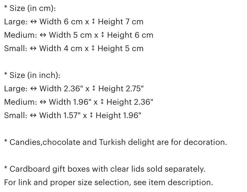May include: A chart showing the size of gift boxes in both inches and centimeters. The chart lists the dimensions for large, medium, and small boxes. The text also states that candies, chocolate, and Turkish delight are for decoration and that cardboard gift boxes with clear lids are sold separately.