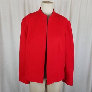 May include: A bright red blazer with a mandarin collar and a tailored fit. The jacket is open in the front and has long sleeves. The fabric appears to be a medium-weight woven material. The blazer is displayed on a mannequin.