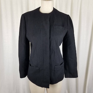 May include: A black wool blazer with a mandarin collar, long sleeves, and two front pockets. The blazer has a single button closure and a slim fit.