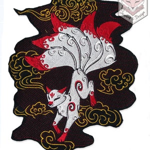 May include: An embroidered iron-on patch depicting a white nine-tailed fox with red accents, set against a black background. The fox is surrounded by gold clouds. The patch is labelled "Karakitsunui Sewing & Design".