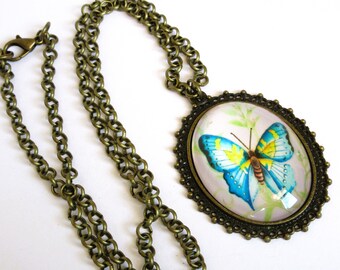 Oval butterfly pendant on 24 inch brass chain, 12