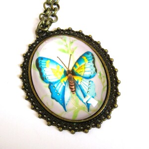 Oval butterfly pendant on 24 inch brass chain, 12