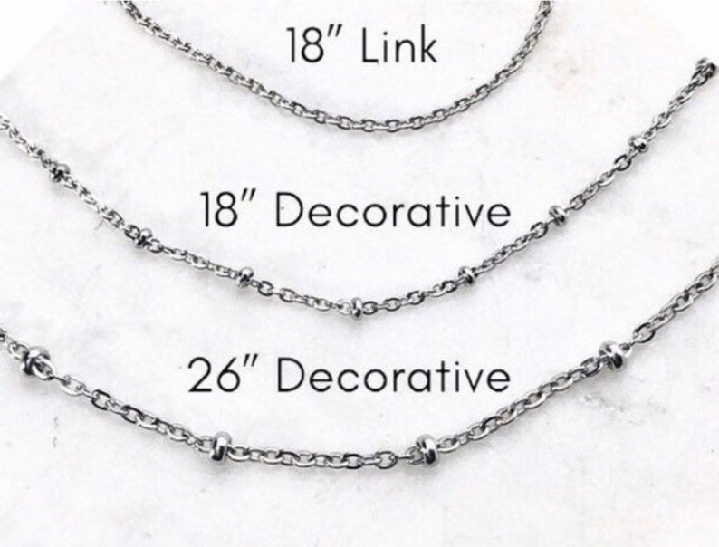 Three silver chains of different lengths, 18 inch link chain, 18 inch decorative chain, and 26 inch decorative chain.