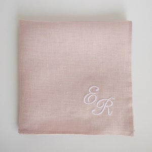 May include: A pale pink linen handkerchief with the embroidered initials "E & R" in white.