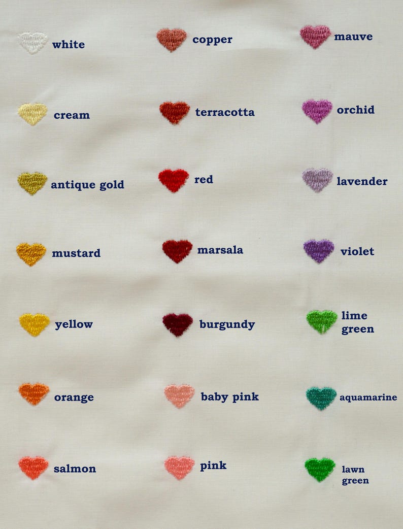 May include: A white fabric sample featuring embroidered heart shapes in various colors. Colors include white, cream, antique gold, mustard, yellow, orange, salmon, copper, terracotta, red, marsala, burgundy, baby pink, pink, mauve, orchid, lavender, violet, lime green, aquamarine, and lawn green.