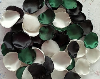 May include: A pile of satin rose petals in black, white, and emerald green.