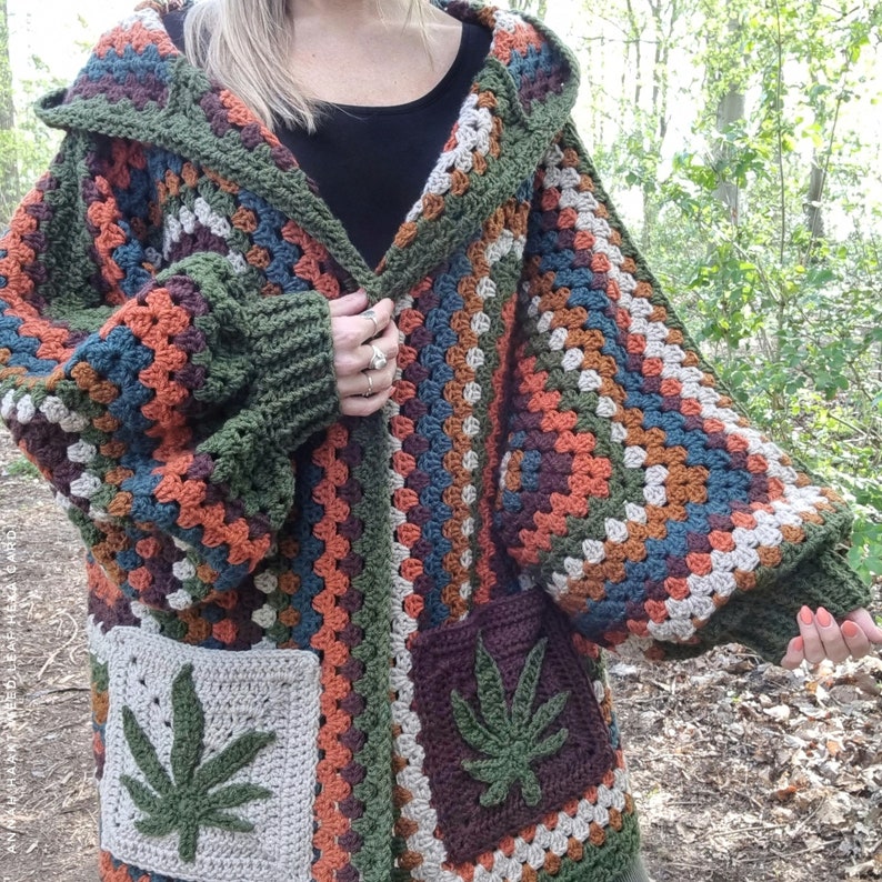 May include: A multi-colored crocheted cardigan with a hood and two large pockets. The pockets feature a green marijuana leaf design.