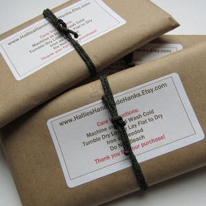 May include: Two rectangular packages wrapped in brown paper, each secured with a dark green cord. A white label on each package features the text www.HalliesHandeHanks.Etsy.com and care instructions including Machine or Hand Wash Cold, Tumble Dry Low, Lay Flat to Dry.