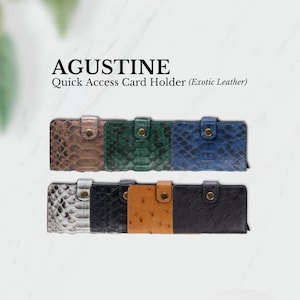 May include: A set of six different colored leather card holders with a snap closure. The card holders are made of exotic leather and have a quick access design. The text "AGUSTINE Quick Access Card Holder (Exotic Leather)" is displayed above the card holders.