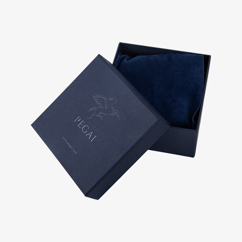 May include: A navy blue gift box with a white Pegasus logo and the text "PEGAI www.pegali.com". The box is open and has a blue velvet lining.