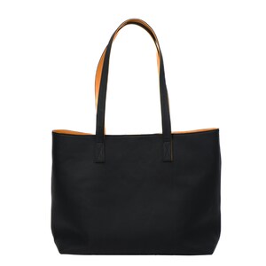 Handcrafted pebbled black leather tote bag for women, made in Spain. Spacious, fits 17" laptop, features cotton lining, calfskin straps, and a detachable pouch. Elegant, durable, perfect for work or as a gift.