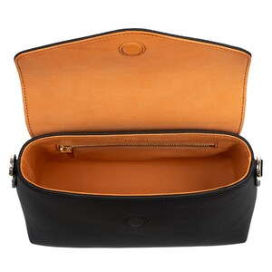 PEGAI Helen Black Pebbled Calfskin Leather Handbag featuring a sleek crossbody design, adjustable metal and leather strap, gold-plated hardware, and a secure magnetic closure. Perfect for a luxurious and stylish look.