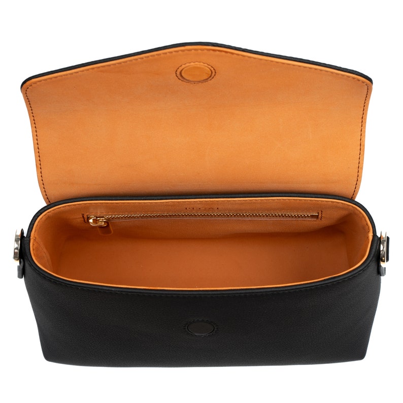 PEGAI Helen Black Pebbled Calfskin Leather Handbag featuring a sleek crossbody design, adjustable metal and leather strap, gold-plated hardware, and a secure magnetic closure. Perfect for a luxurious and stylish look.