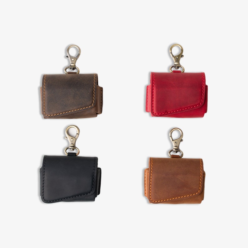 Flat lay of classic leather AirPods cases with keychains—crafted for travel ease, gifting, or minimalist carry.