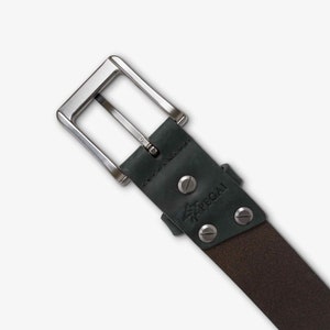 May include: A dark brown leather belt with a silver buckle and a black logo that says "PEGAL" with a tree design.