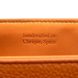 PEGAI Helen Black Pebbled Calfskin Leather Handbag featuring a sleek crossbody design, adjustable metal and leather strap, gold-plated hardware, and a secure magnetic closure. Perfect for a luxurious and stylish look.