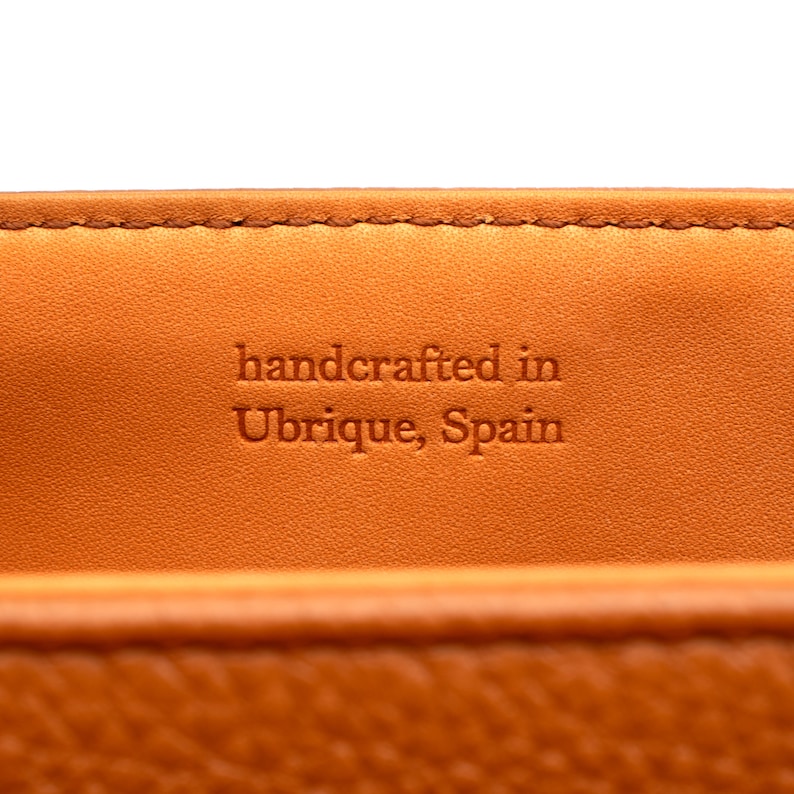 PEGAI Helen Black Pebbled Calfskin Leather Handbag featuring a sleek crossbody design, adjustable metal and leather strap, gold-plated hardware, and a secure magnetic closure. Perfect for a luxurious and stylish look.