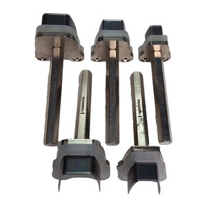 May include: Set of five silver metal leather hole punch tools with a black rubber top and the text "TANNENSTEIN" on the side.