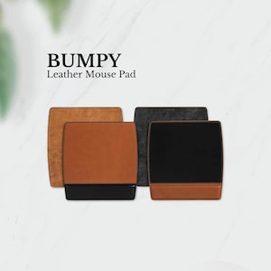 May include: Three leather mouse pads in different colors: brown, black, and gray. The mouse pads have a stitched edge and a smooth surface. The text "BUMPY Leather Mouse Pad" is displayed above the mouse pads.