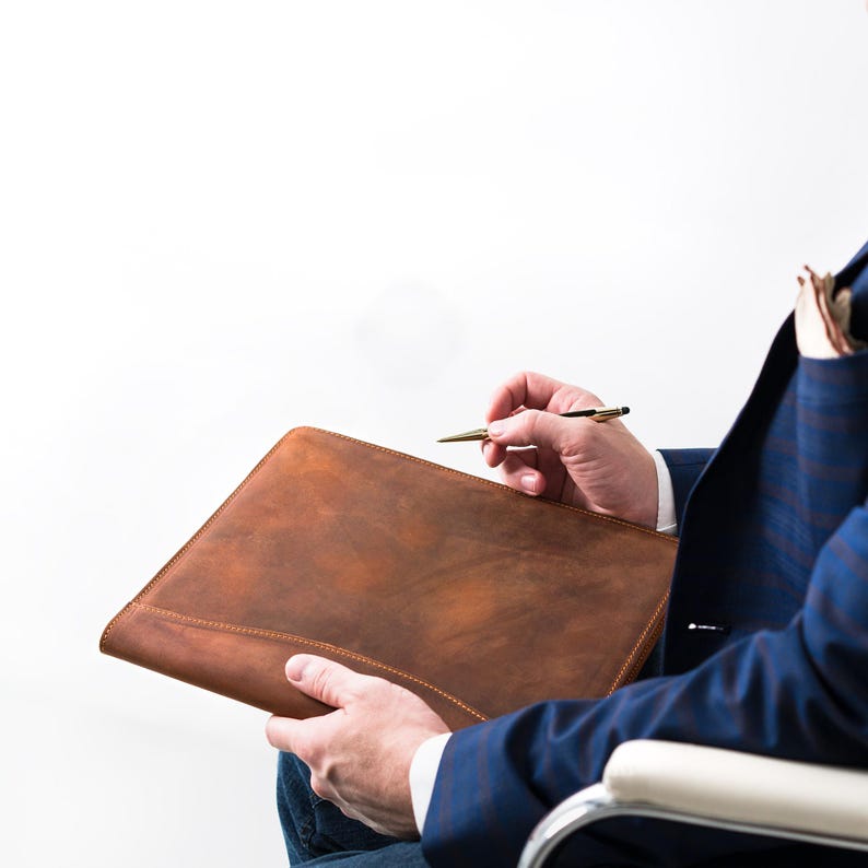 A professional carries a Marshall Mahogany folio—rugged elegance in hand, ideal for meetings, pitches, or gifting with heart.