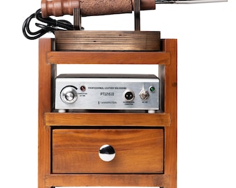 May include: A wooden stand with a drawer holds a leather soldering tool and a control unit. The control unit is labeled "Professional Leather Soldering PT12610 TANNERSTEIN".